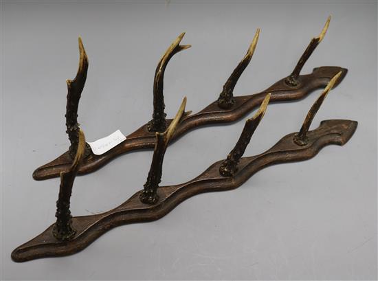 A pair of antler gun rack holders